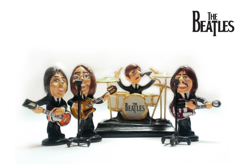 three bobble heads in a band with an electric guitar