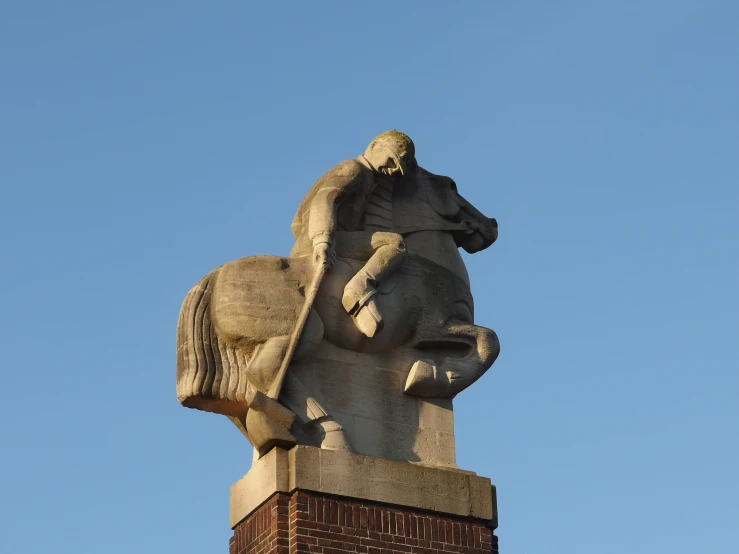 an image of statue of man on horse in the middle of a town