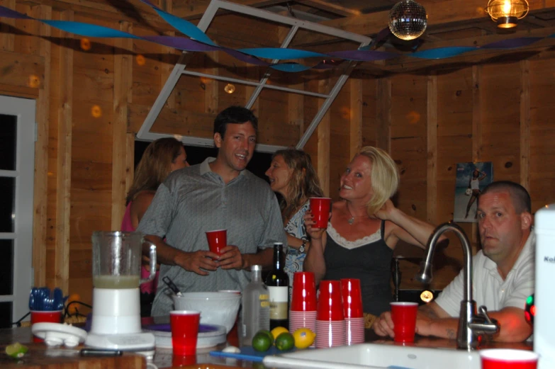 group of people having drinks in wooden room
