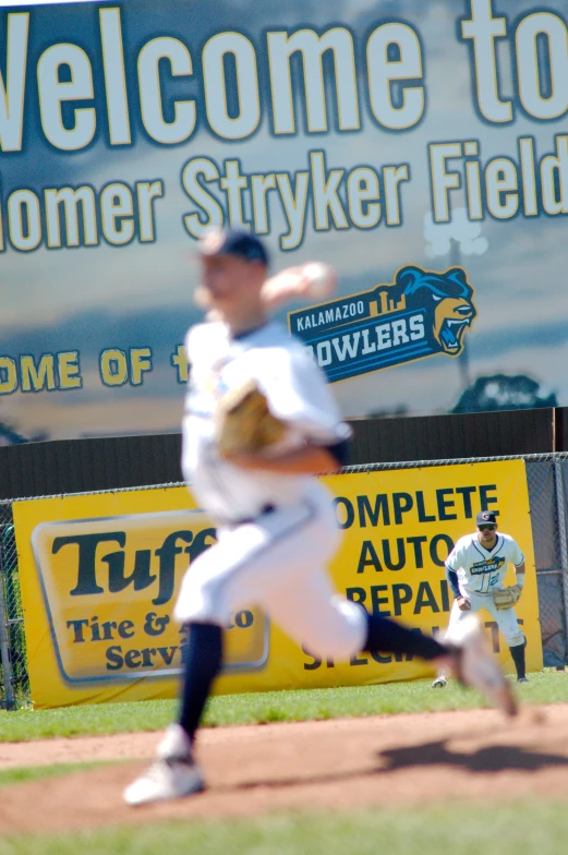 a pitcher throwing a ball at the baseball game