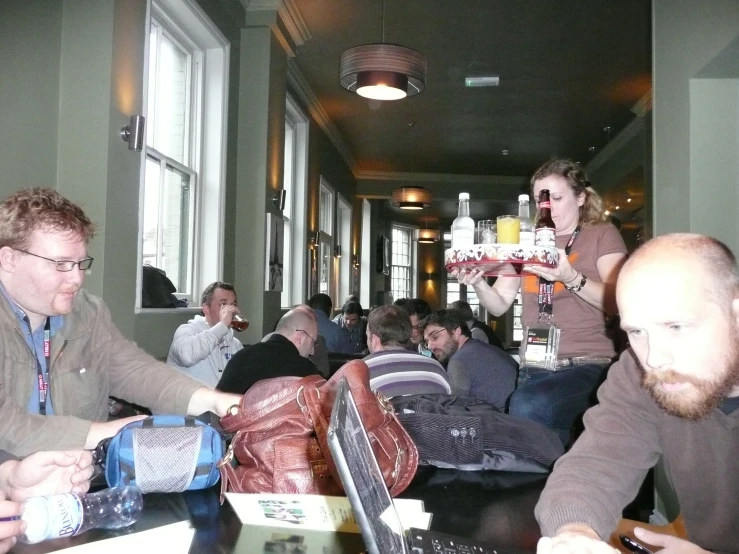 several people sitting around a table having drinks