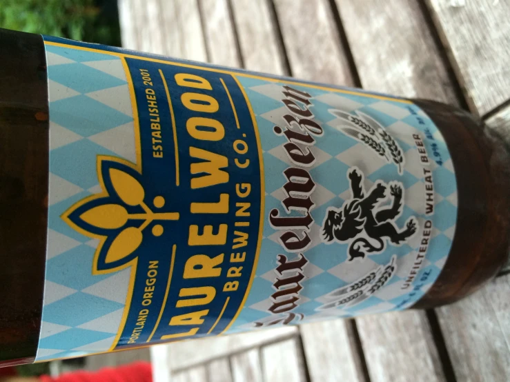 a bottle of beer on top of a wooden table