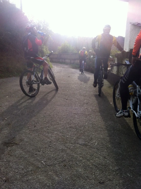 a group of people standing on top of dirt near bicycles