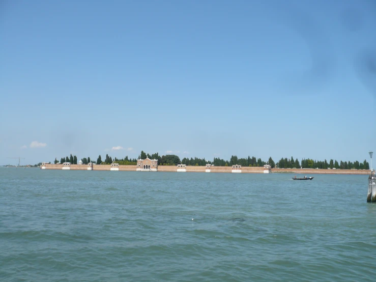 a body of water with a buoy in the distance