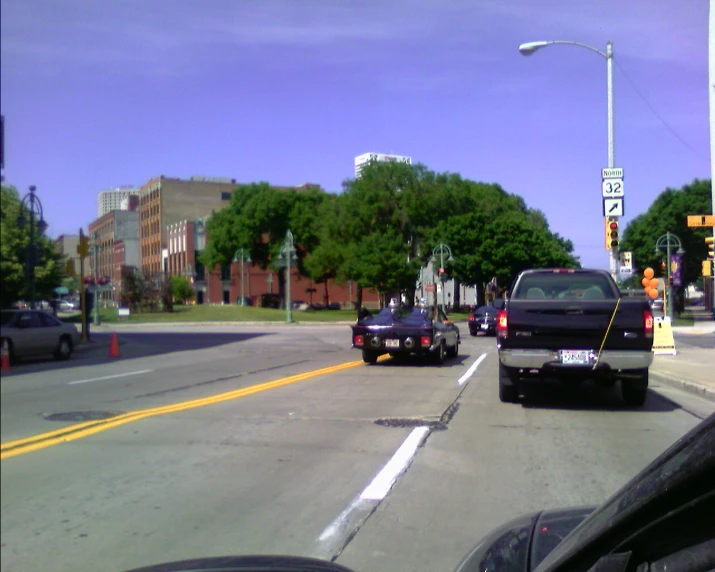 a couple of vehicles that are driving down a street