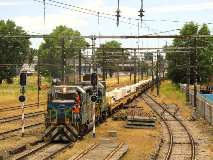 a train coming down the track into a crossing