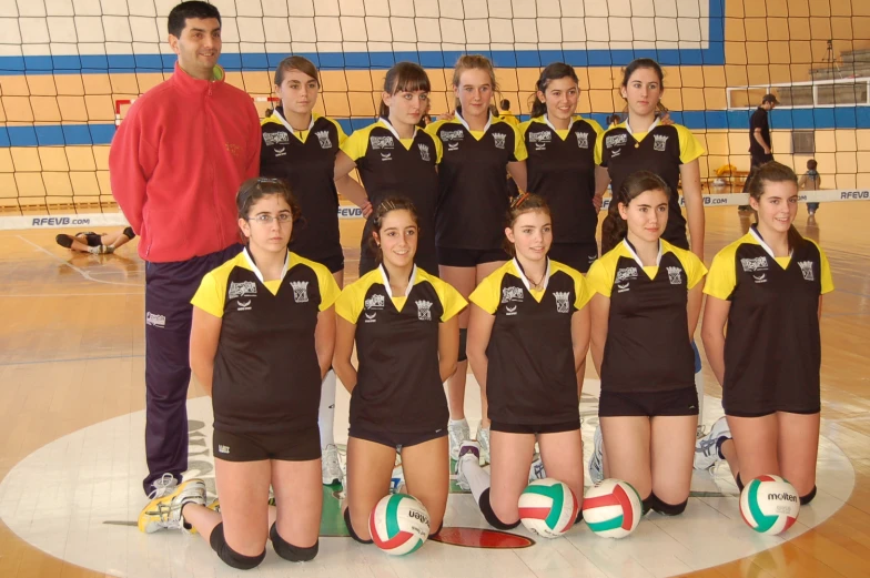 a team of girls are standing together on a court