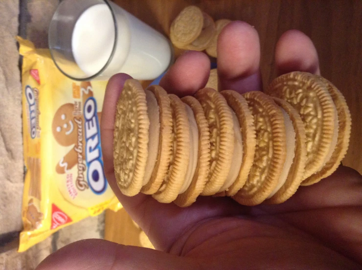 a hand holding a stack of peanut er cookies