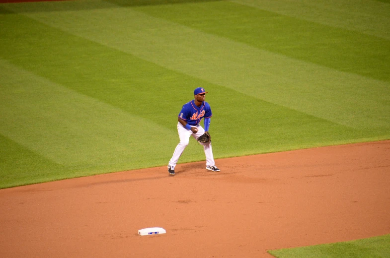 the player in blue jersey is pitching the ball