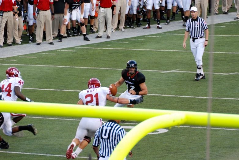 two teams of football players in action on the field