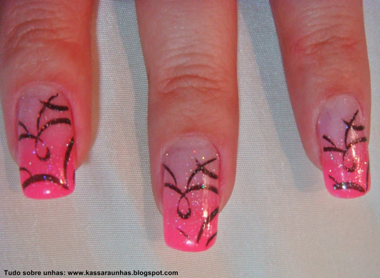 the nail has been decorated with pink and black designs