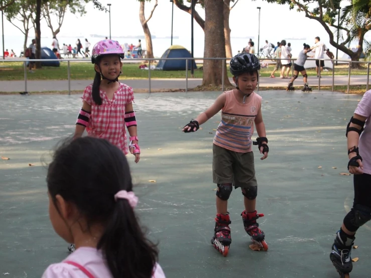 a group of young people riding skateboards on a play area