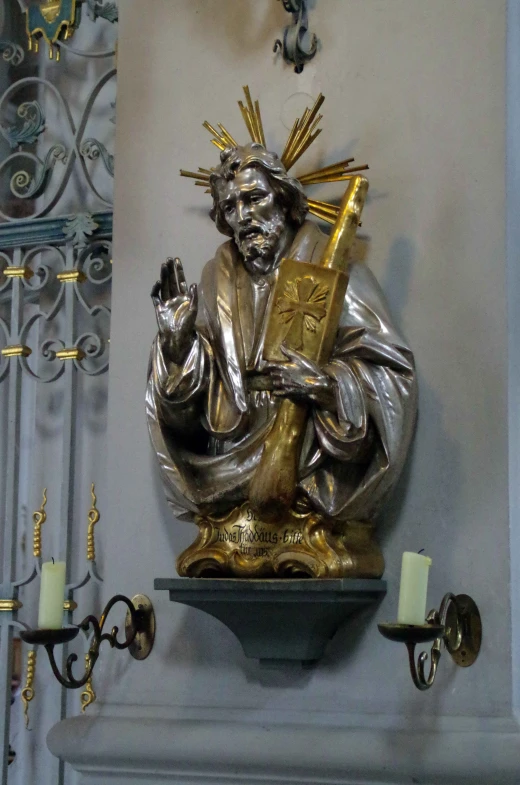 a golden statue with gold colored accents and a crown