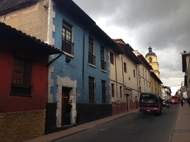 a truck is parked in a street between two buildings