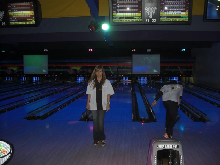 a person standing on a skateboard in a bowling alley