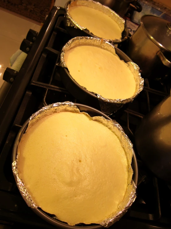 five pie pans on the stove ready for the oven