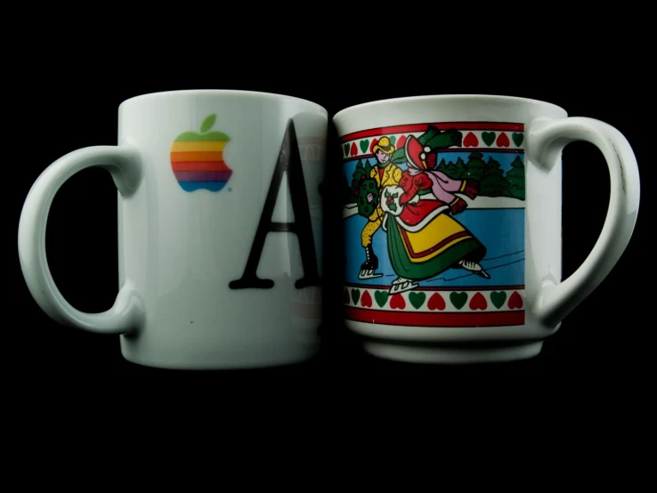 two coffee mugs with the letter a on one of them