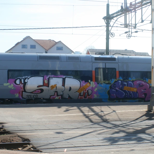 a train with graffiti in front of it