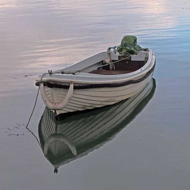 a small boat is floating on calm water