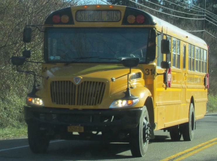 a yellow school bus moving down a road