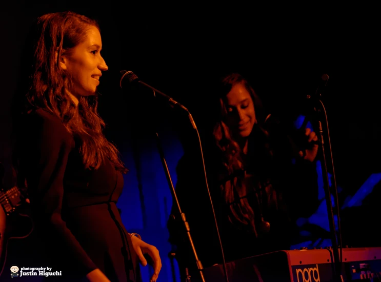 the woman is standing in front of a microphone