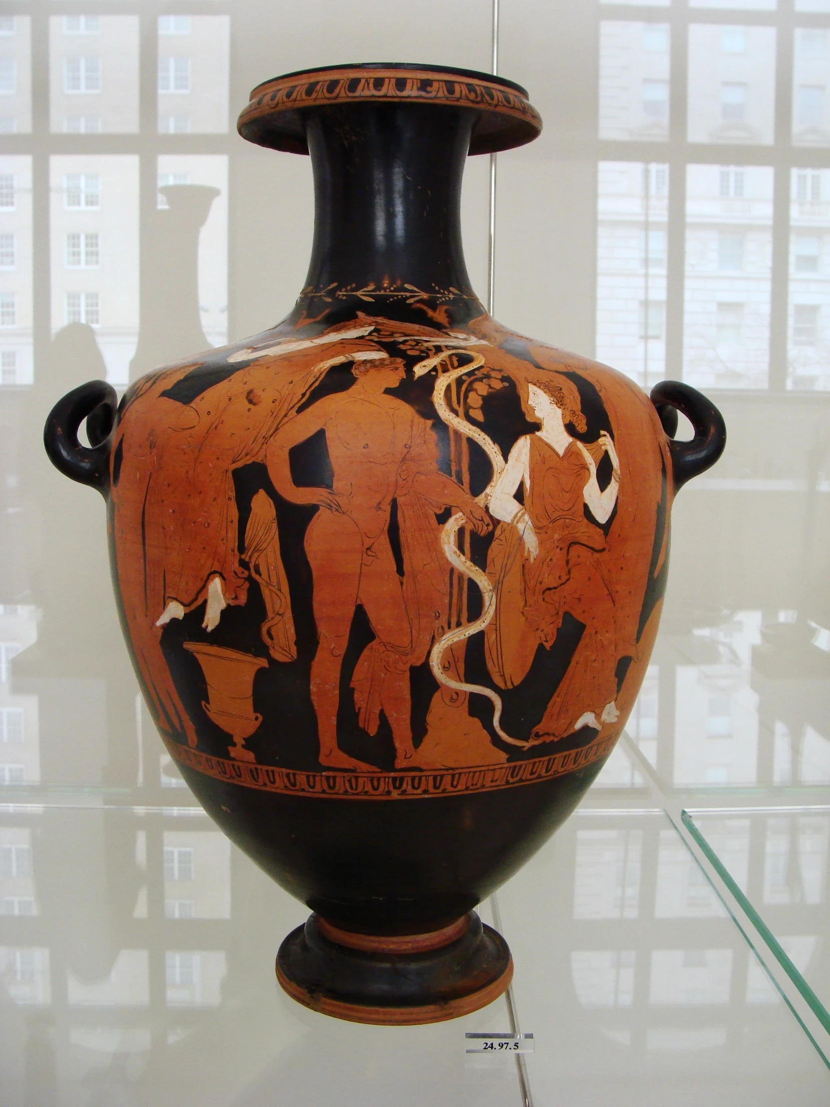 an ancient black and red urn with people on it