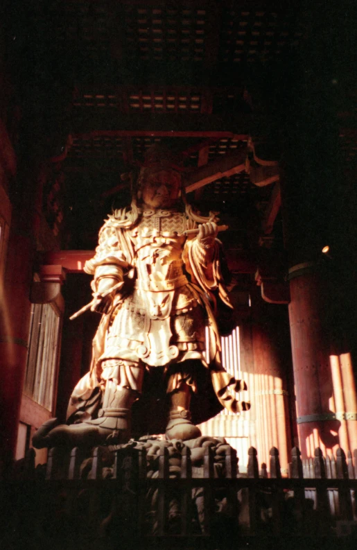 statue of buddha in ancient temple with large columns