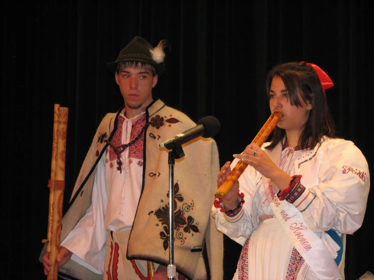 man and woman in historical costumes playing flute