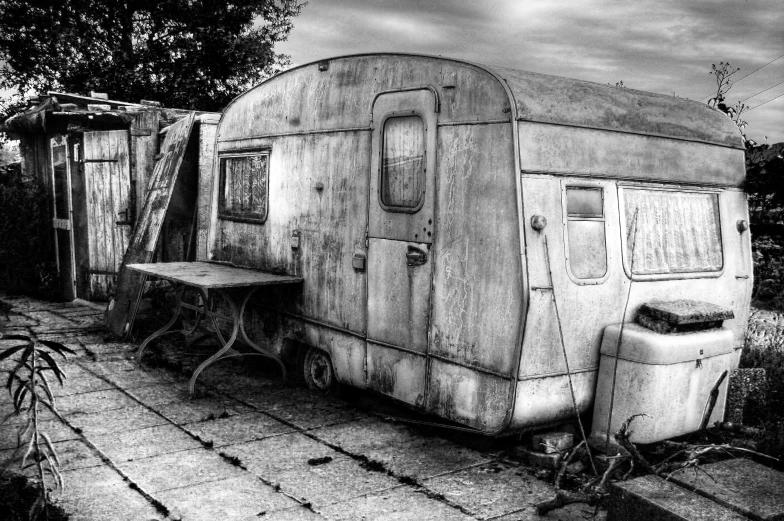 an old trailer is shown sitting in the yard