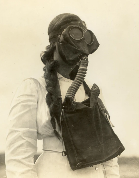 a vintage po of a woman wearing a diving suit with gas mask