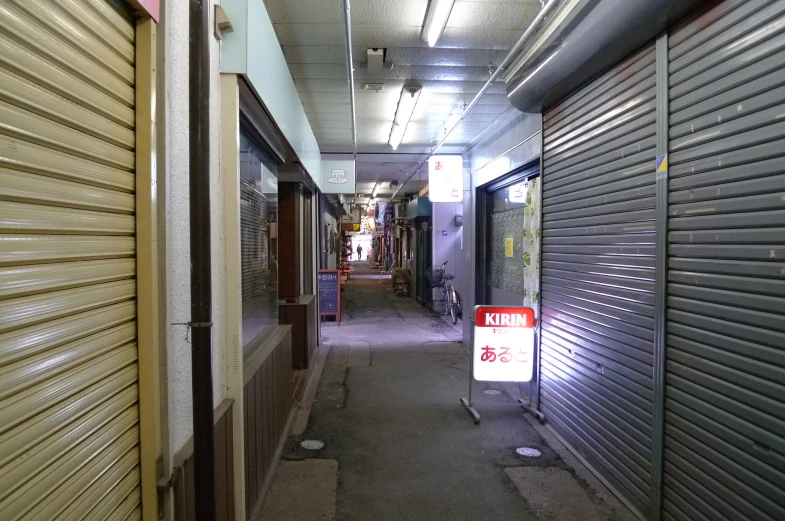 an empty warehouse with some storage doors and a sign that reads'keep off