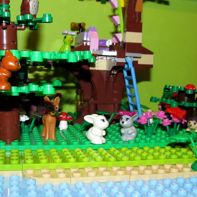 a lego toy forest with animals is on the table