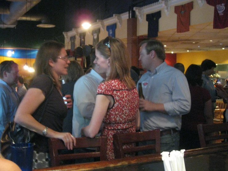 two people standing near a bar looking at each other