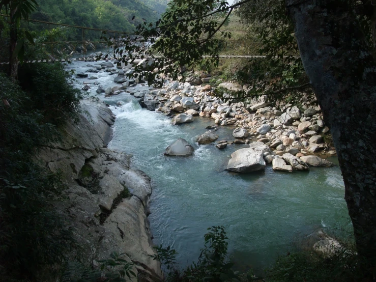 a river running between two rocks and trees