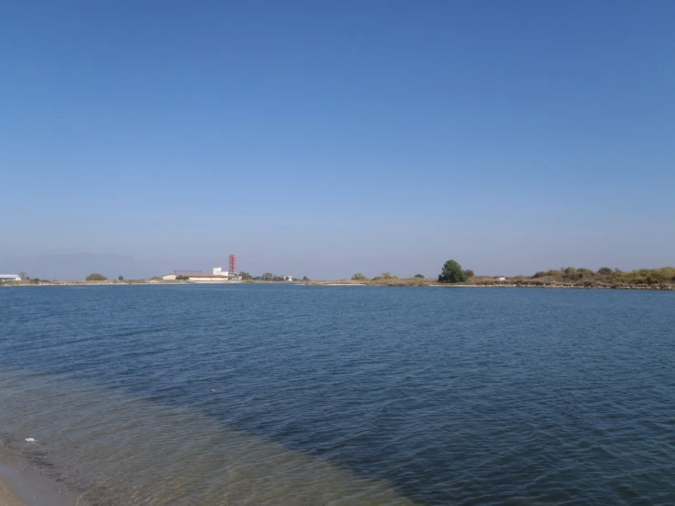 the view over a long lake toward the factory