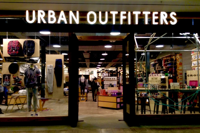 an urban outfitters store with large mirrors showing people shopping