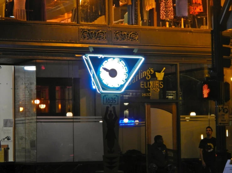 neon sign at night with man walking out of the window