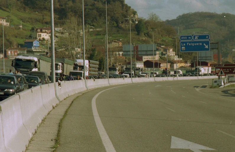 a group of trucks that are driving down the street