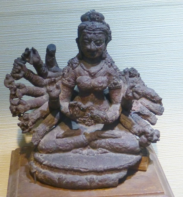 a statue with many hands surrounding it