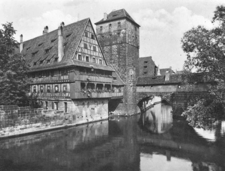 an old building next to the river and bridge