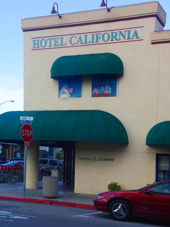 the building has green and red awnings on its windows