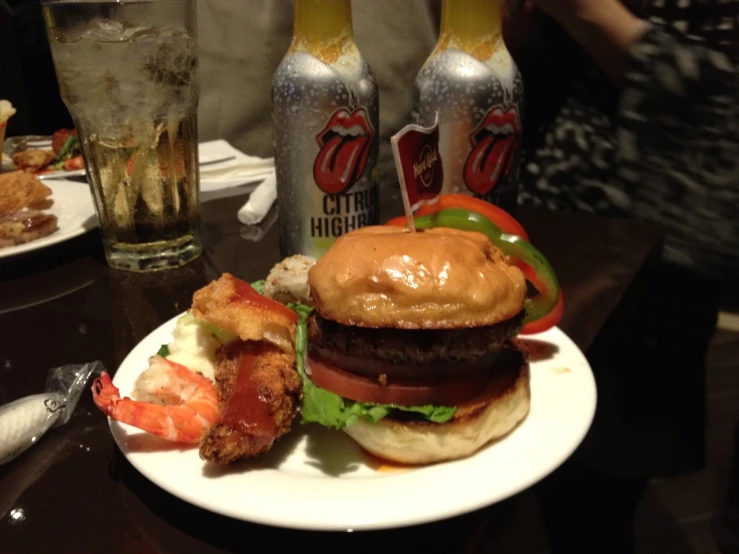 a plate of hamburger, potatoes and tomatoes