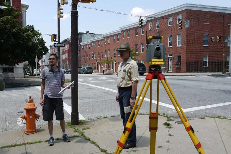 two men are standing on the side of the road