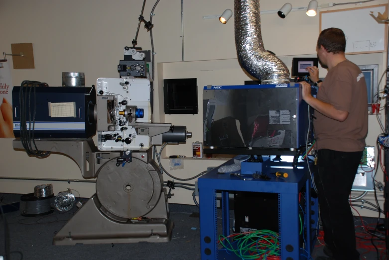 a person in a factory looking at an object