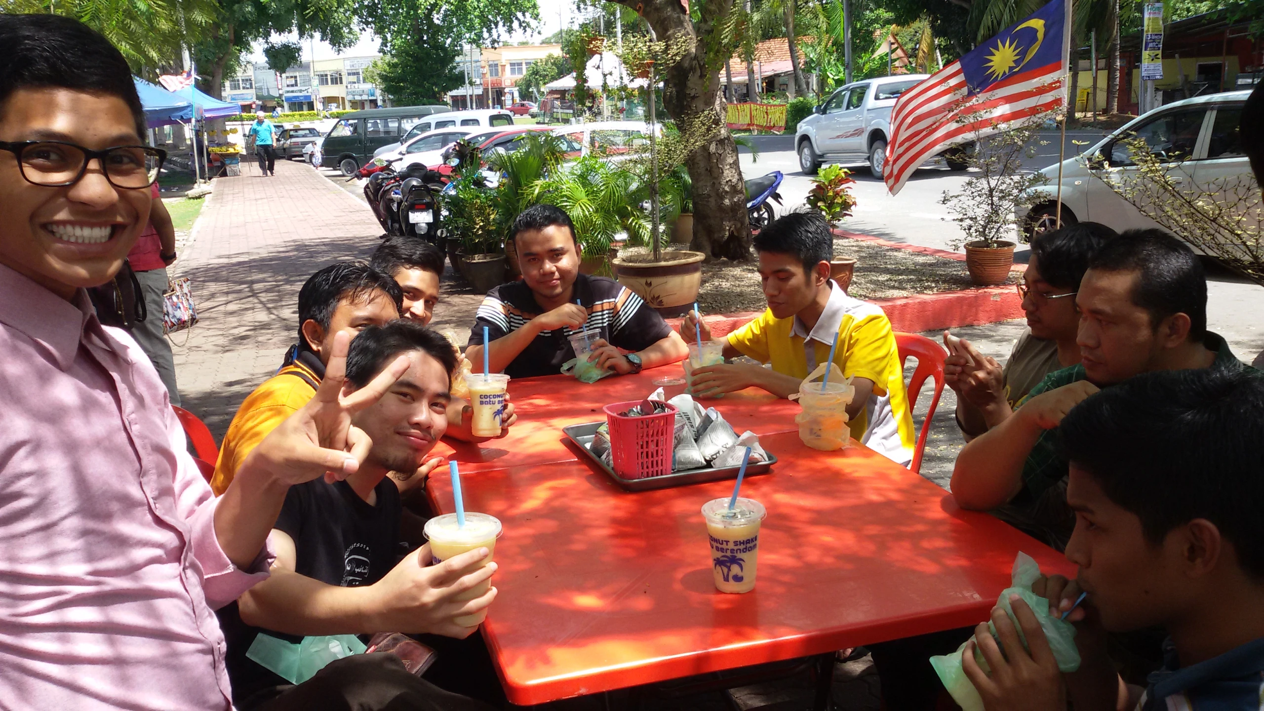 people sitting around a red table drinking coffee