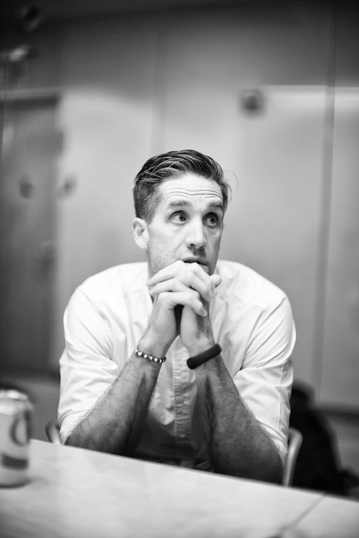 a man sitting at a table in front of a mirror