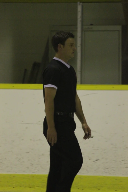 a man skateboarding with one foot on the ground