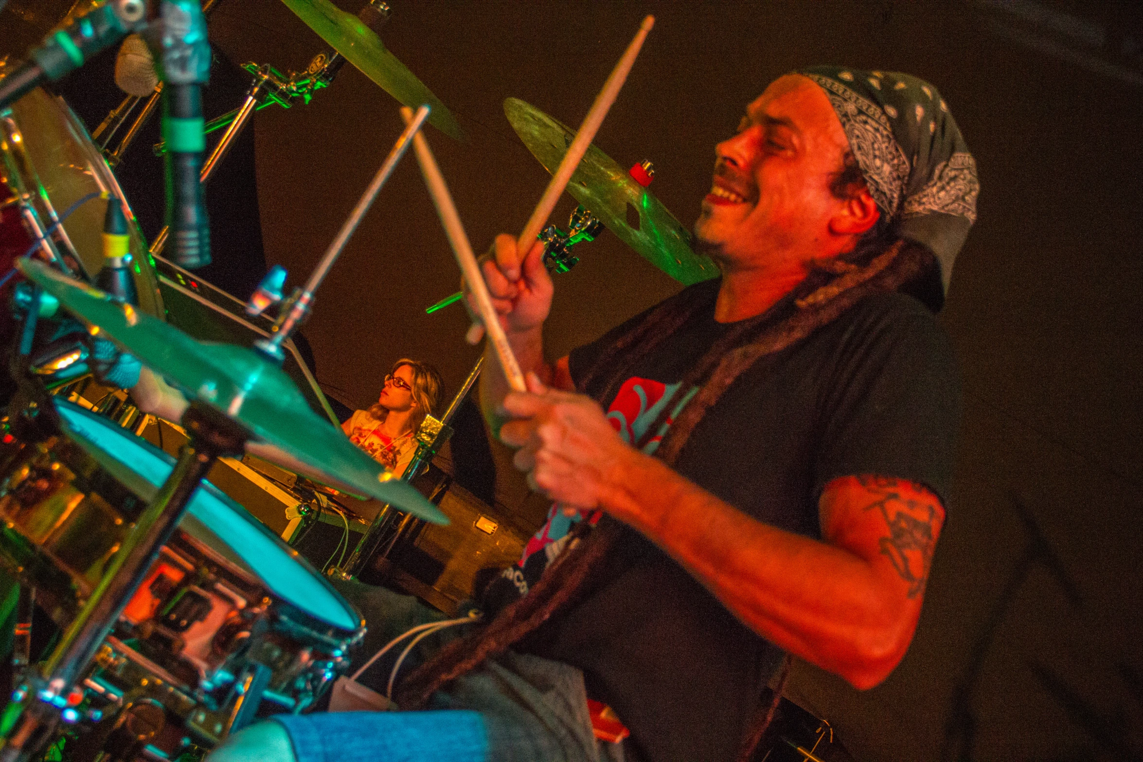 a man that is sitting behind a drums