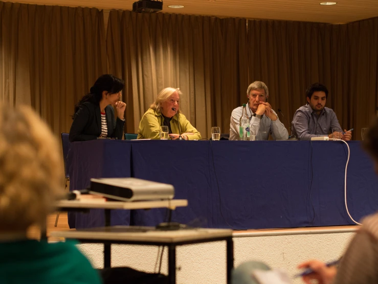 people sitting at desks in a conference room