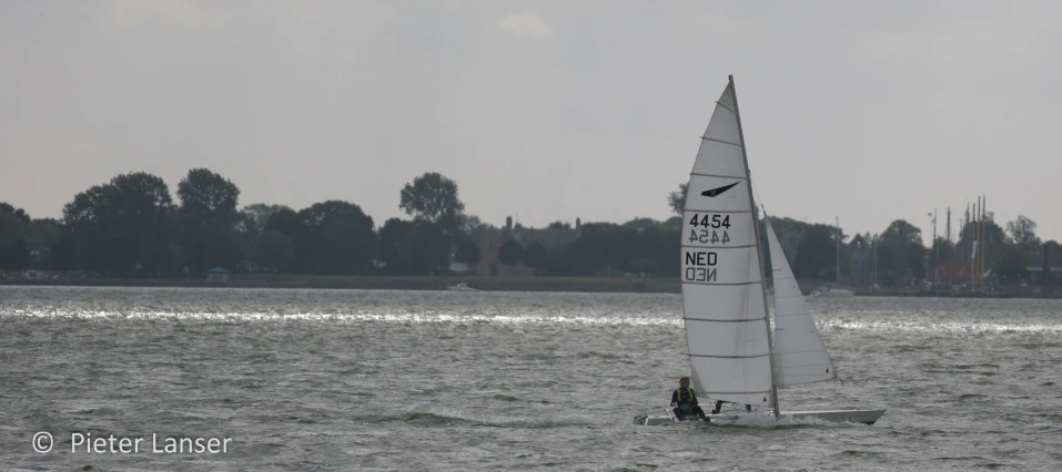 a sailboat sailing in the middle of the water
